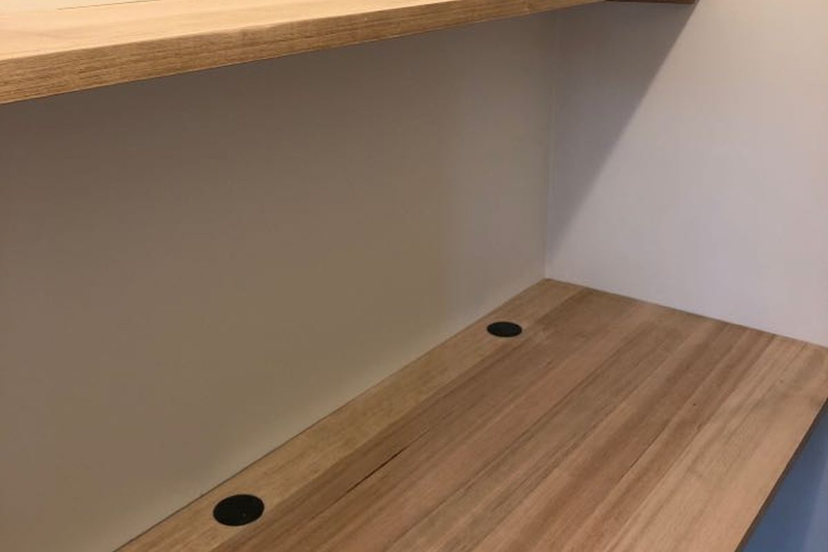Built-in timber study desk and floating shelf with cable holes, made by JFM