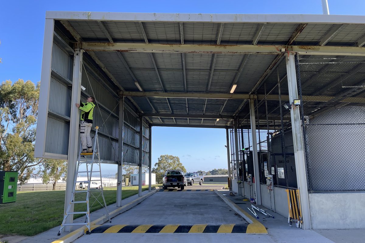 Steel structure being treated for rust from an elevated work platform