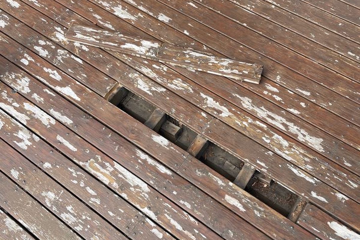 Broken and worn boards on a deck before a JFM repair