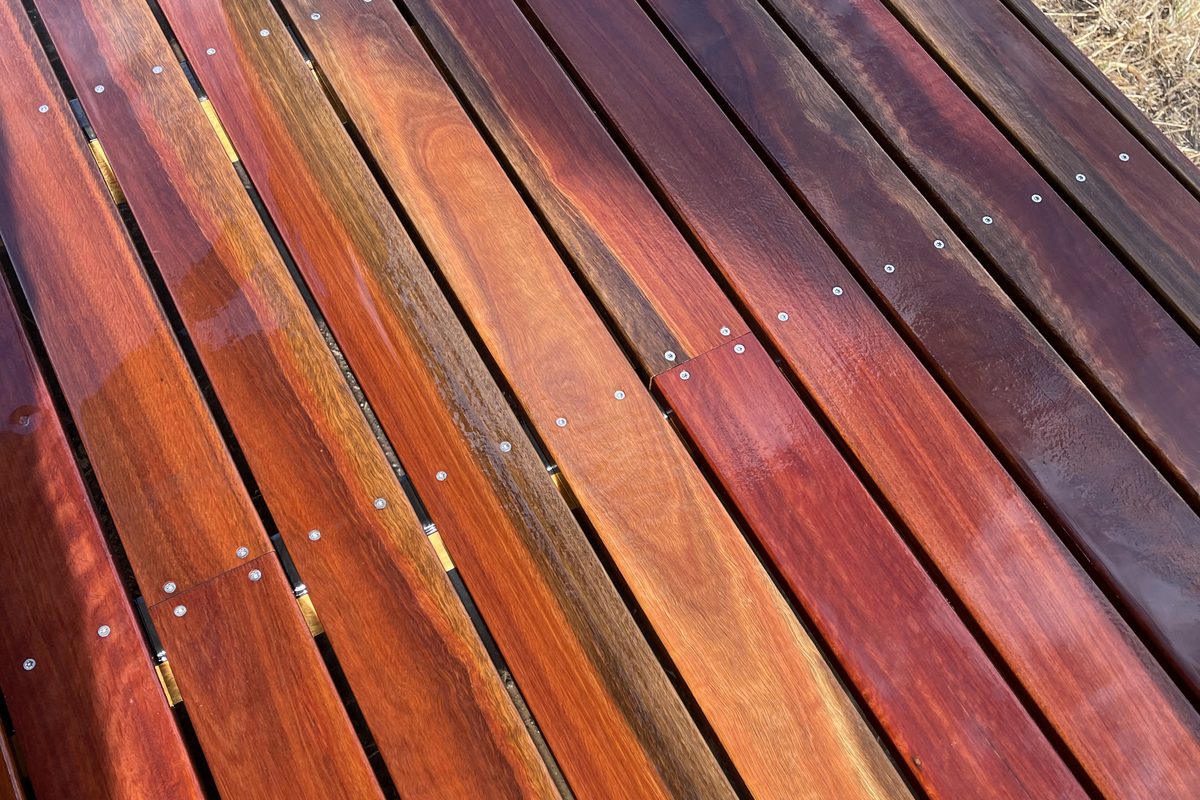 Merbau deck half oiled by JFM, with the colour coming back beside the bare boards
