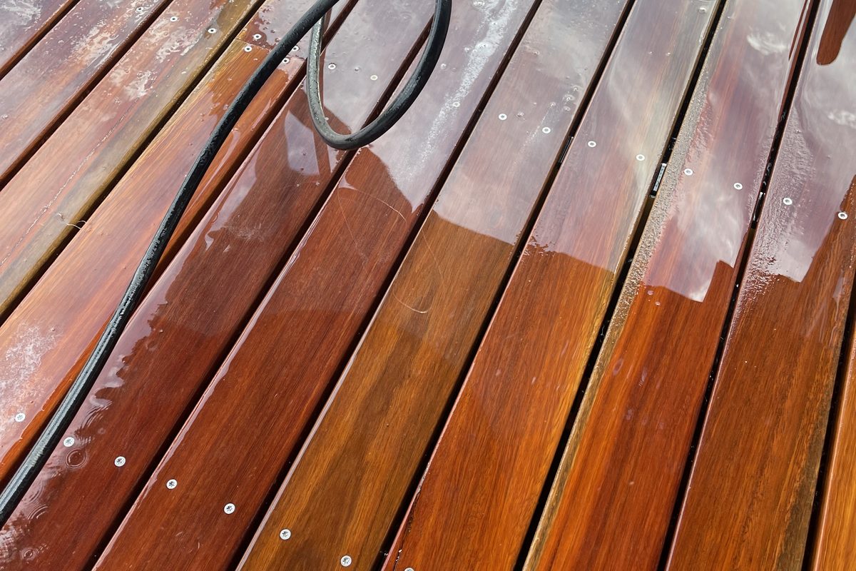 Oil going on a merbau deck, darkening the boards as it soaks in