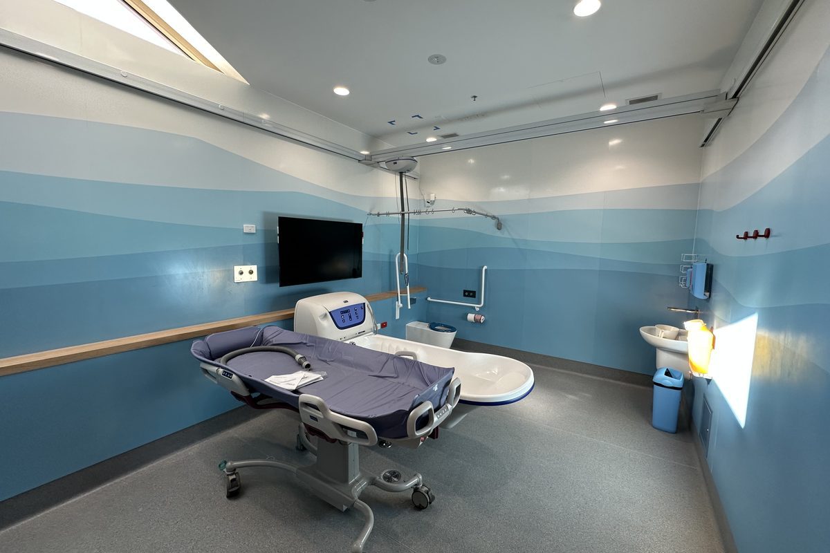 Hospital room with ceiling lifting track and wall fittings