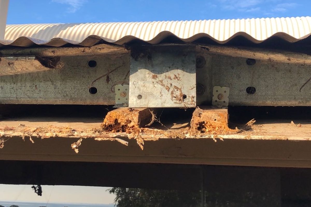 Rotted fascia exposed with the gutter off during a fascia replacement