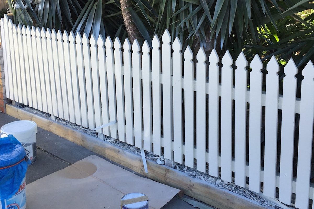 White picket fence being painted by JFM