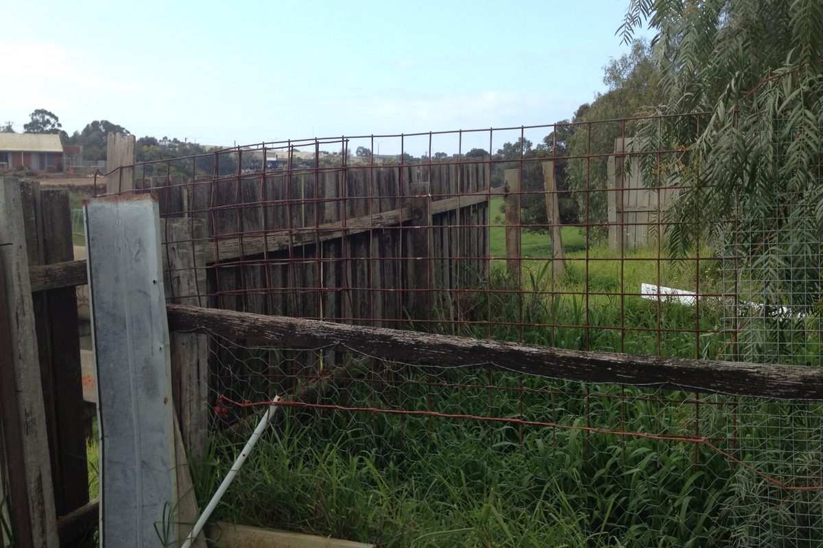 Leaning paling fence and broken wire fence before JFM repaired it