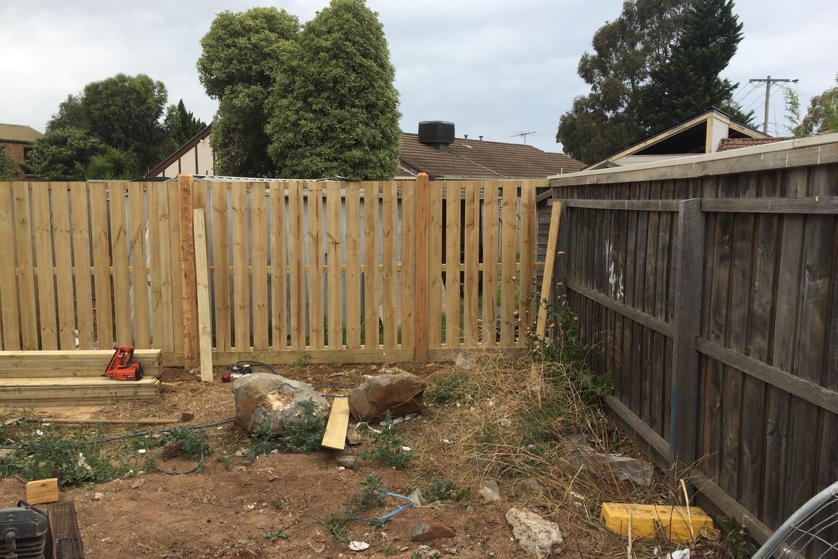 New section of paling fence joined beside an older weathered fence by JFM