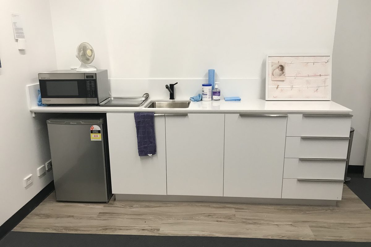 Office kitchenette with cupboards, drawers and a bar fridge space