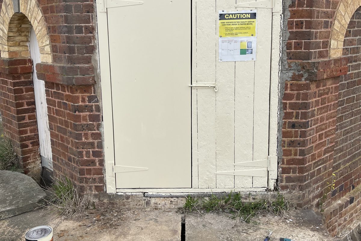 New ledged timber doors made to match and painted on a heritage brick building