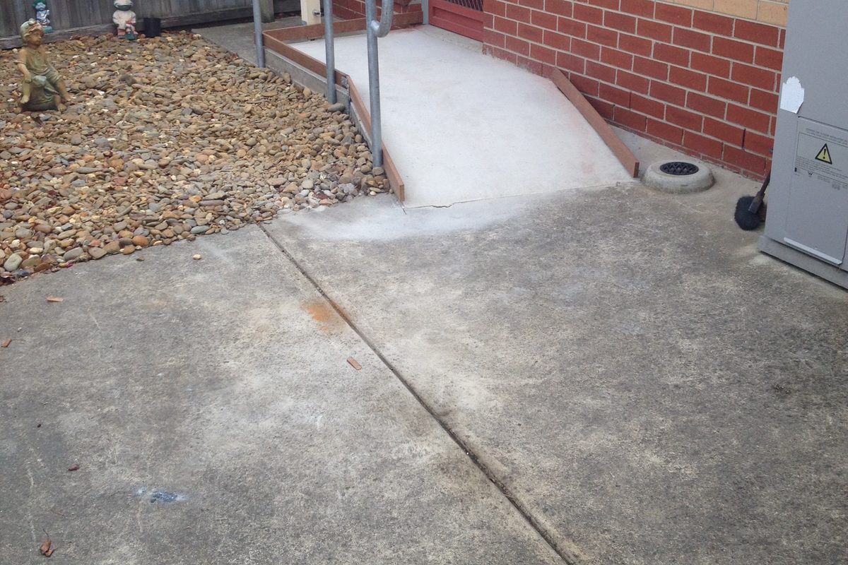 Handrail beside a short ramp to a side door