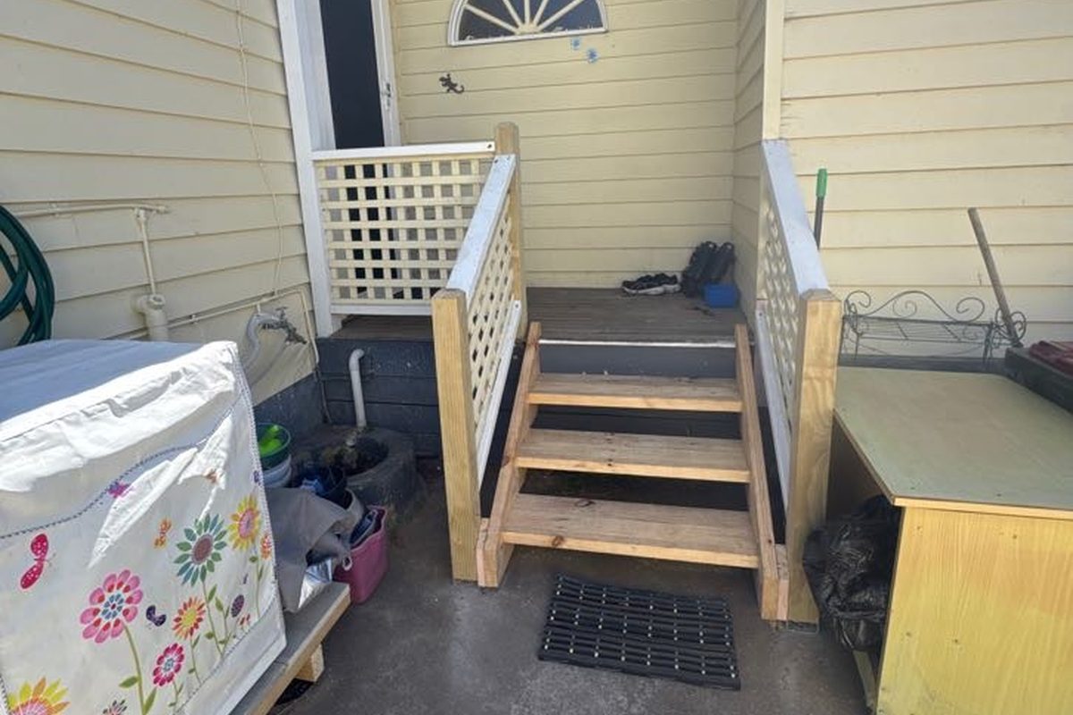 New treated pine steps and lattice at the back door of a rental