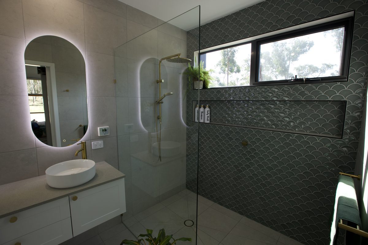 Renovated bathroom with green feature tiles, walk-in shower and double vanity