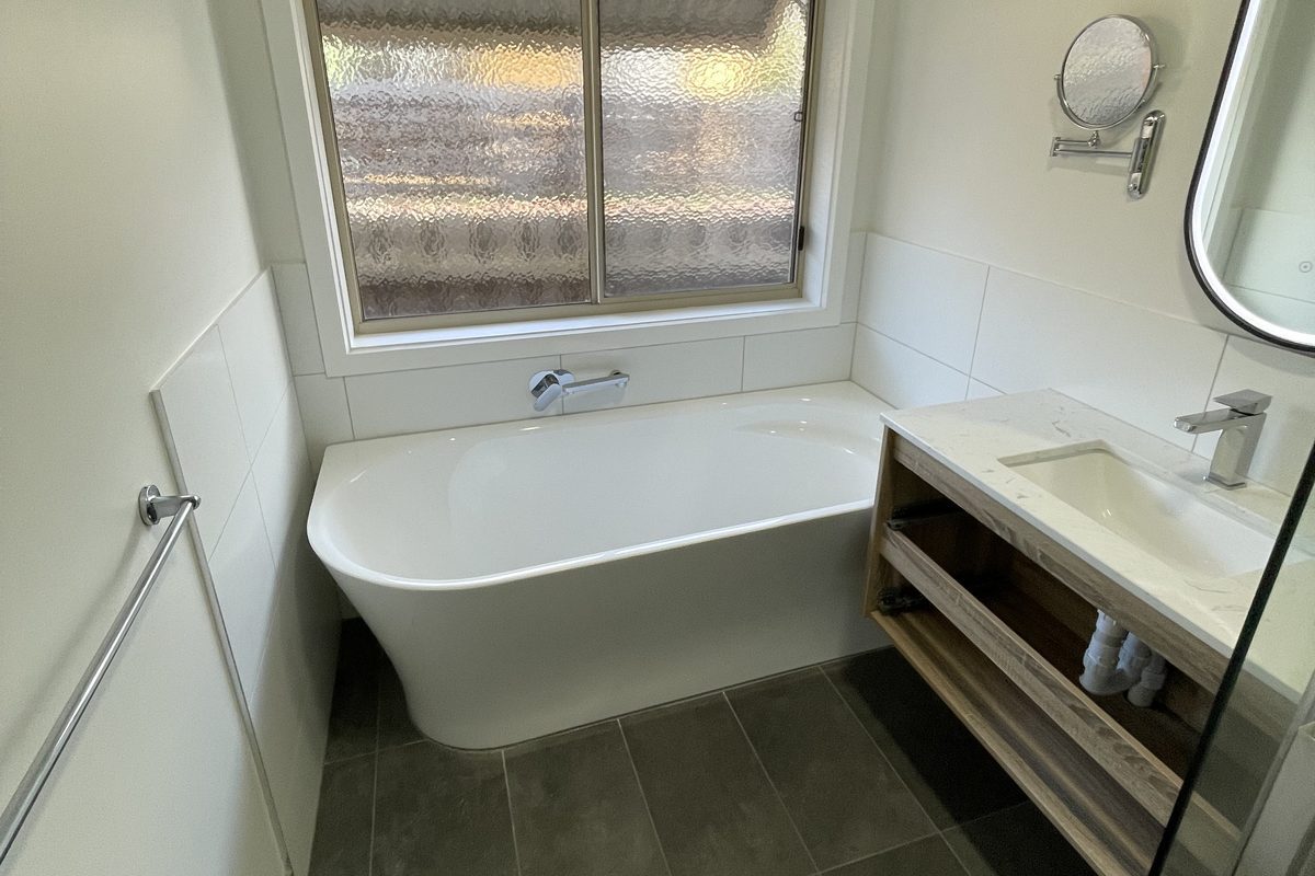 Renovated bathroom with freestanding bath and timber vanity, Highton