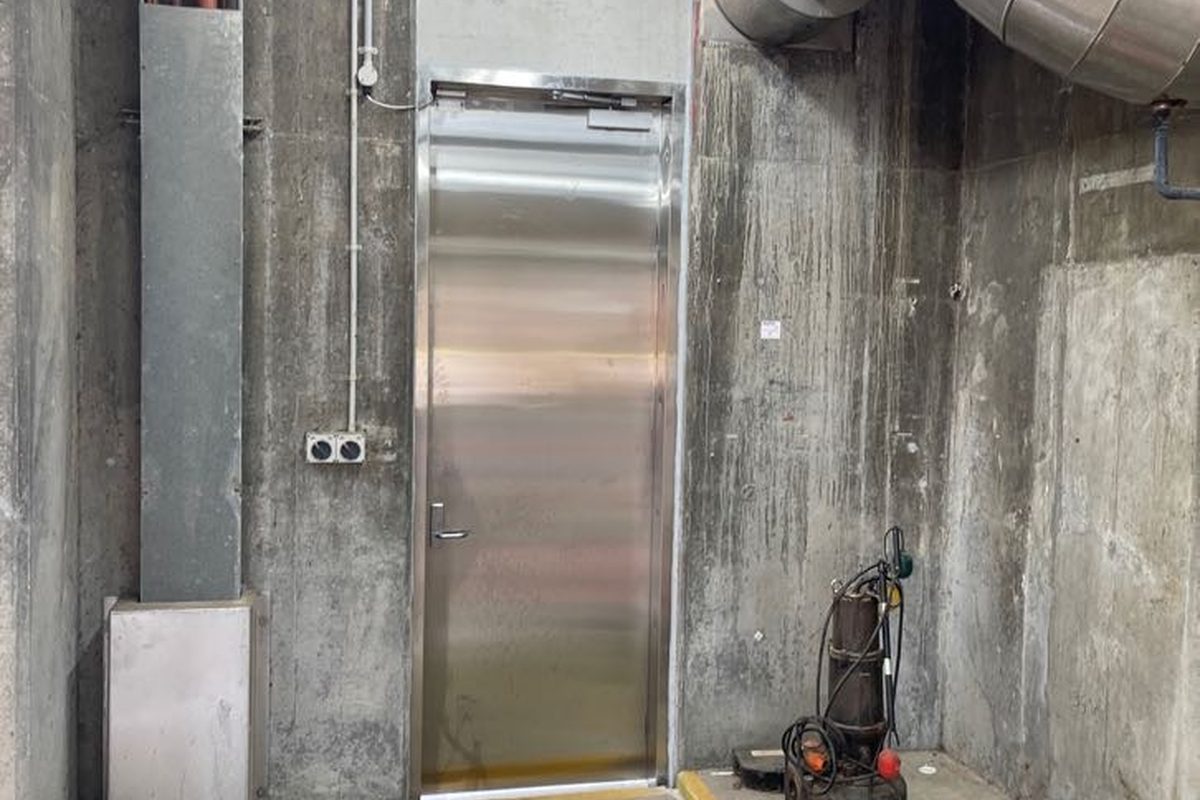 Stainless steel door fitted in a concrete plant room