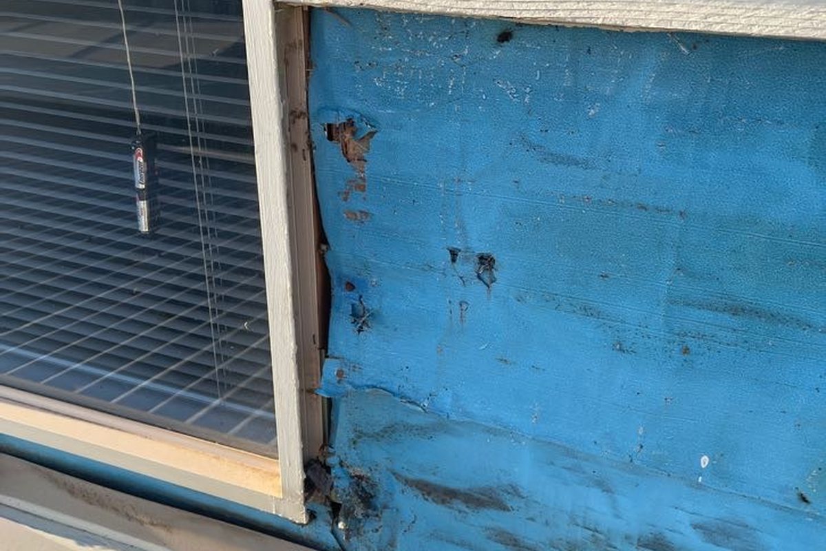 Weatherboards taken off around a window so the side flashing can go in, Leopold