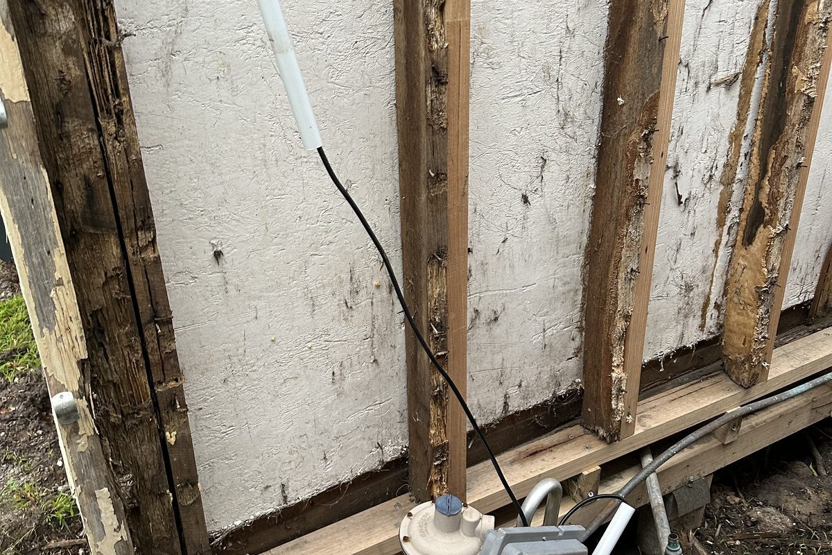 Rotten weatherboards removed to expose the frame behind