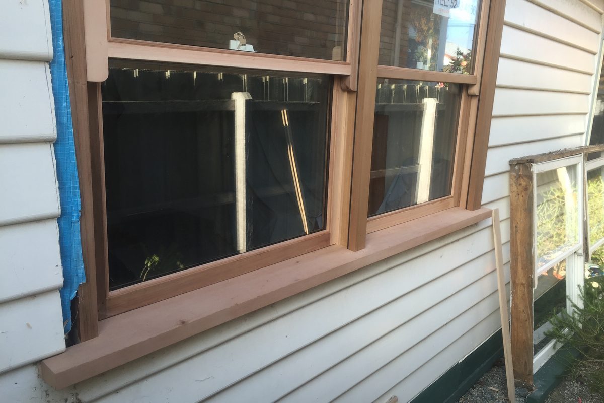 New timber window frame going into a weatherboard wall