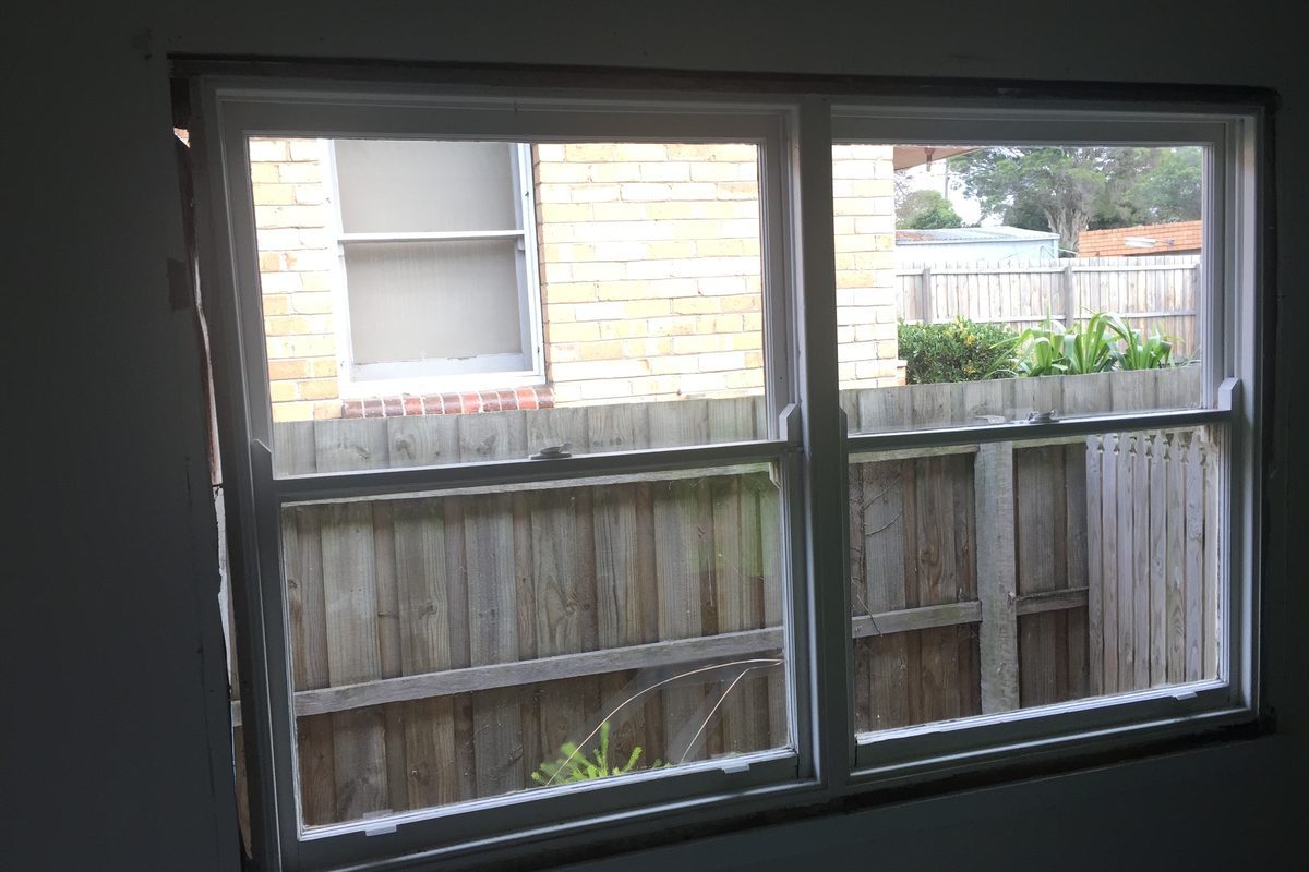 New double-hung timber window seen from inside the room