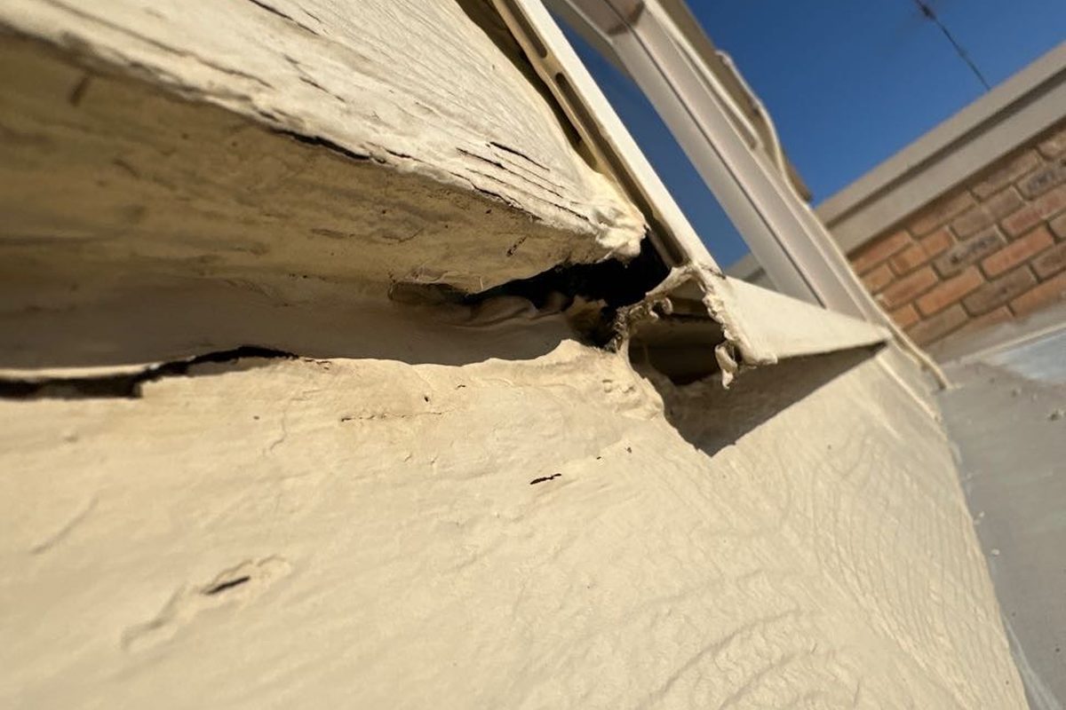 Rotted corner of a window sill and frame on a Leopold home before repair