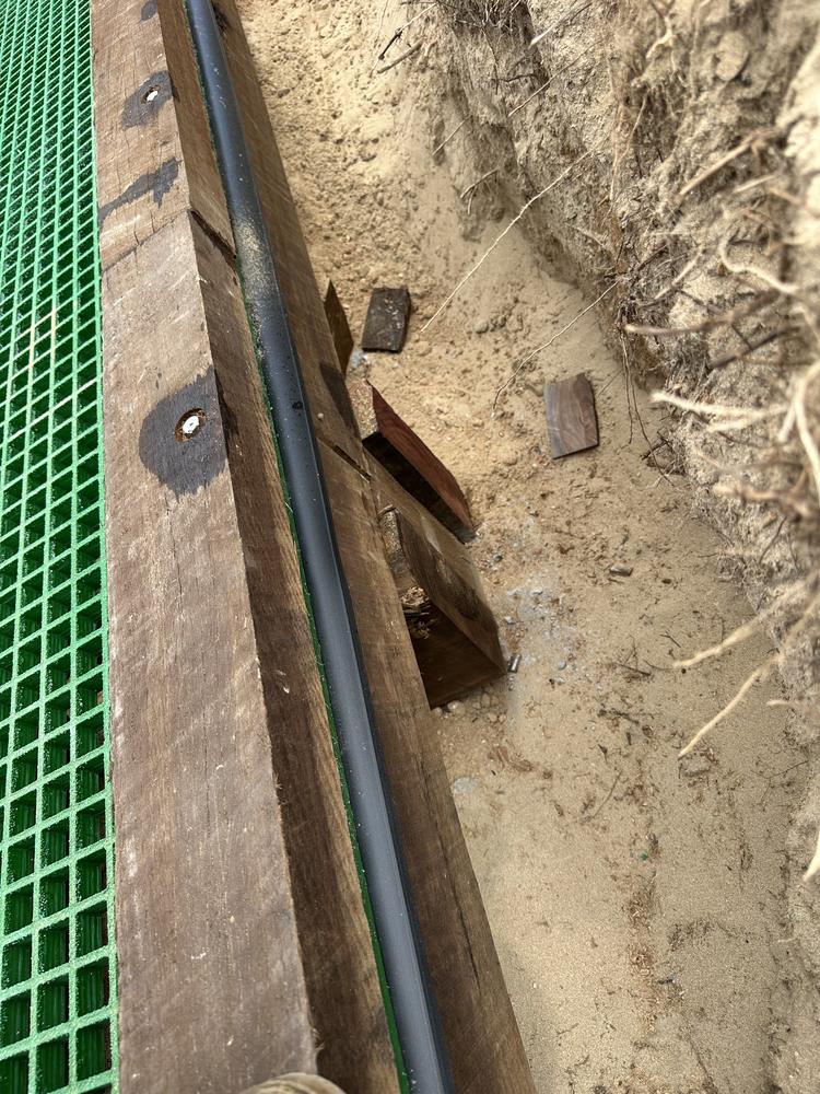 The hardwood frame and posts, already filling in with wind-blown sand