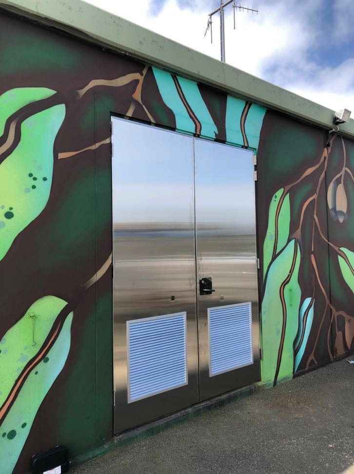 New polished 316 stainless steel doors on a coastal site