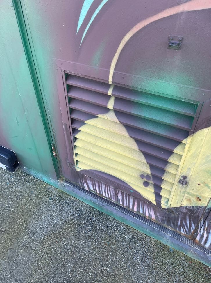 The old clad door corroded at the base around the vent